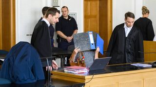 Die Angeklagten Ismail I. und Nina R. mit ihren Verteidigern Daniel Heinlein (l.) und Alexander Kiefer beim Prozessauftakt im August.