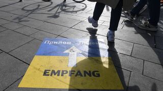 Ein Hinweisschild weist den ankommenden ukrainischen Flüchtlingen den Weg zur Erstversorgung - hier am Kölner Hauptbahnhof.