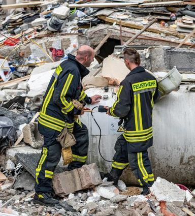 Feuerwehrleute zwischen den Trümmern in Hemer.
