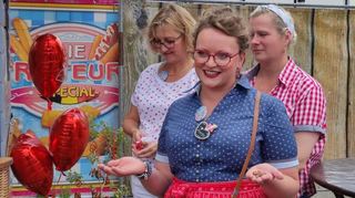 Benita Barth weiht mit Schaustellerkolleginnen den neuen Stand des Verkehrsvereins ein – mit Glückspfennigen. Das ist ein alter Brauch der Beschickerszene.