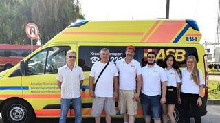 Das Team des ASB um Herwin Hadameck (3.v.l.) bei der Übergabe der Kranken-transportwagen mit zwei Vertretern aus Czernowitz.