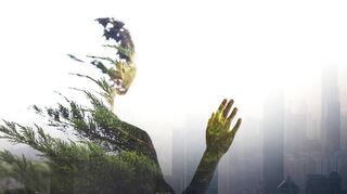 Person standing in contemplation in smog urban city reflection with nature trees