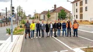 Bürgermeister Ralf Eisenhauer (4.v. l.) und MWSP-Geschäftsführer Achim Judt (3.v.l.) mit den Projektbeteiligten in der Robert-Funari-Straße.