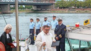Pfarrerin Anne Ressel und Landespolizeidekan Bernhard Metz sprechen Fürbitten und segnen das Polizeiboot.