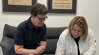 Susanne Deß von der Abendakademie und Angela Cutasevici, stellvertretende Bürgermeisterin von Chisinau, unterschreiben die Erklärung.