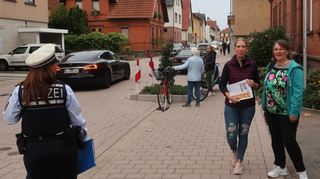Eine Polizistin des Postens Heddesheim (v.l.) sowie Myrjam Hermanns und Dagmar Knispel überwachen den Verkehr vor der Hans-Thoma-Grundschule.