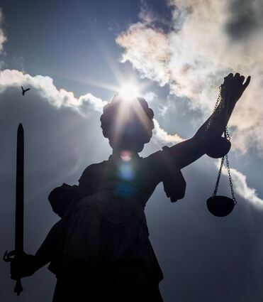 Das Bild zeigt eine Statue der Justitia auf dem Gerechtigkeitsbrunnen auf dem Römerberg in Frankfurt am Main. Ein Gericht hat die Schuld des Mörders festgestellt. Kann er auf Vergebung hoffen?
