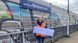 Projektleiterin Julia Schneweis mit einem Bauplan am Bahnhof Mannheim-Neckarstadt.
