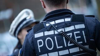 Stuttgart: Eine Polizistin (l) und ein Polizist gehen im Rahmen eines Fototermins eine Straße entlang (gestellte Szene).