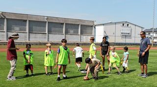 Tyrone Booker (r.) von den Redskins brachte den Ferienspielkindern der Bärenhöhle Grundlagen des Flag-Football bei. Ihn unterstützten Co-Trainer Noah Thiel (mit Hut) und Tochter Zoe (schwarzes T-Shirt).