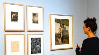 Eine Frau steht vor einigen Werken der neuen Sonderausstellung „hart & direkt. Zeichnung und Grafik der Neuen Sachlichkeit“ in der Kunsthalle Mannheim.