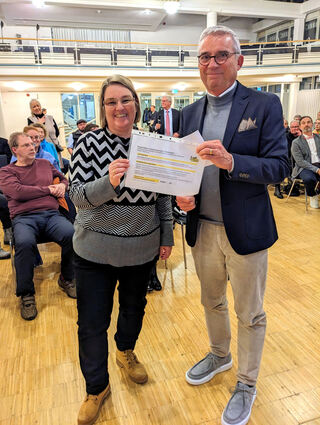 BI-Sprecherin Dagmar Knispel übergibt dem Landesminister und Vize-Ministerpräsident Thomas Strobl in Heddesheim die Kernargumente gegen das auf besten Ackerböden geplante Umspannwerk Mannheim-Ost.