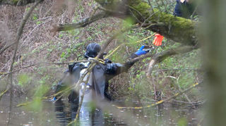 Taucher durchsuchen einen Tümpel bei Bad Schönborn. Dort wurde die Leiche der Großmutter des Entführten Mädchens gefunden.