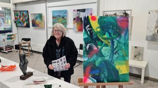 Marianne Merz in ihrem Kunstkubus mit den Bildern von Ingrid Gromer. Rechts neben ihr das Bild „Wild at Heart“.