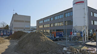 Von außen sieht das neue Schulhaus schon so gut wie fertig aus. Im Hof gibt es noch einiges zu tun. Nach dem Umzug soll der alte Bau links im Bild abgerissen werden.