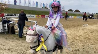 Und noch eine Maimarkt-Gewinnerin: Die sechsjährige Julie-Ann Dehner landet beim Turnier auf dem Mühlfeld mit ihrem sechsjährigen Einhorn, alias Welsh-Ponny Emmi auf Platz ein des Wetbewerbs "Kostümiertes Führzügelreiten".