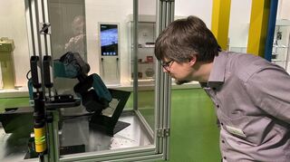 Kurator Dr. Martin Weiss und sein Lieblingsstücke, der Zeichen-Roboter Horst.