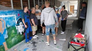 Graffiti-Künstler „Rise One“ gibt den Teilnehmenden Tipps.
