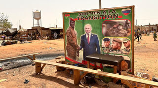Russlands Präsident Putin und Burkina Fasos militärischer Übergangspräsident Traoré (l.) sind gemeinsam auf einem Poster auf einer Straße in einem Vorort der burkinischen Hauptstadt Ouagadougou zu sehen.
